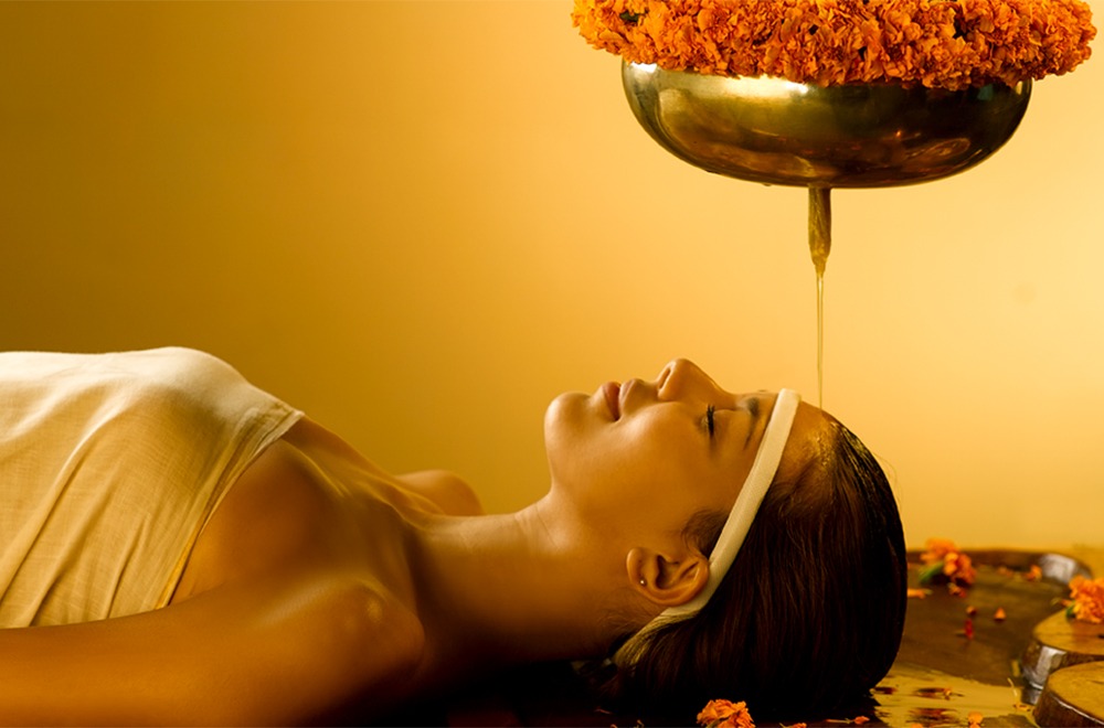 Spa setup with essential oils, towels, and flowers